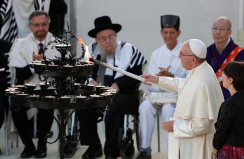 Pope Francis lights a candle during an interfaith peace gathering outside the Basilica of St. Francis in Assisi, Italy, Sept. 20. The pope and other religious leaders were attending a peace gathering marking the 30th anniversary of the first peace encounter. (CNS photo/Paul Haring) See ASSISI-ECUMENISM-WELBY, ASSISI-BARTHOLOMEW-TRIBUTE, ASSISI-CHRISTIAN-PRAYER, POPE-ASSISI-PEACE Sept. 20, 2016.